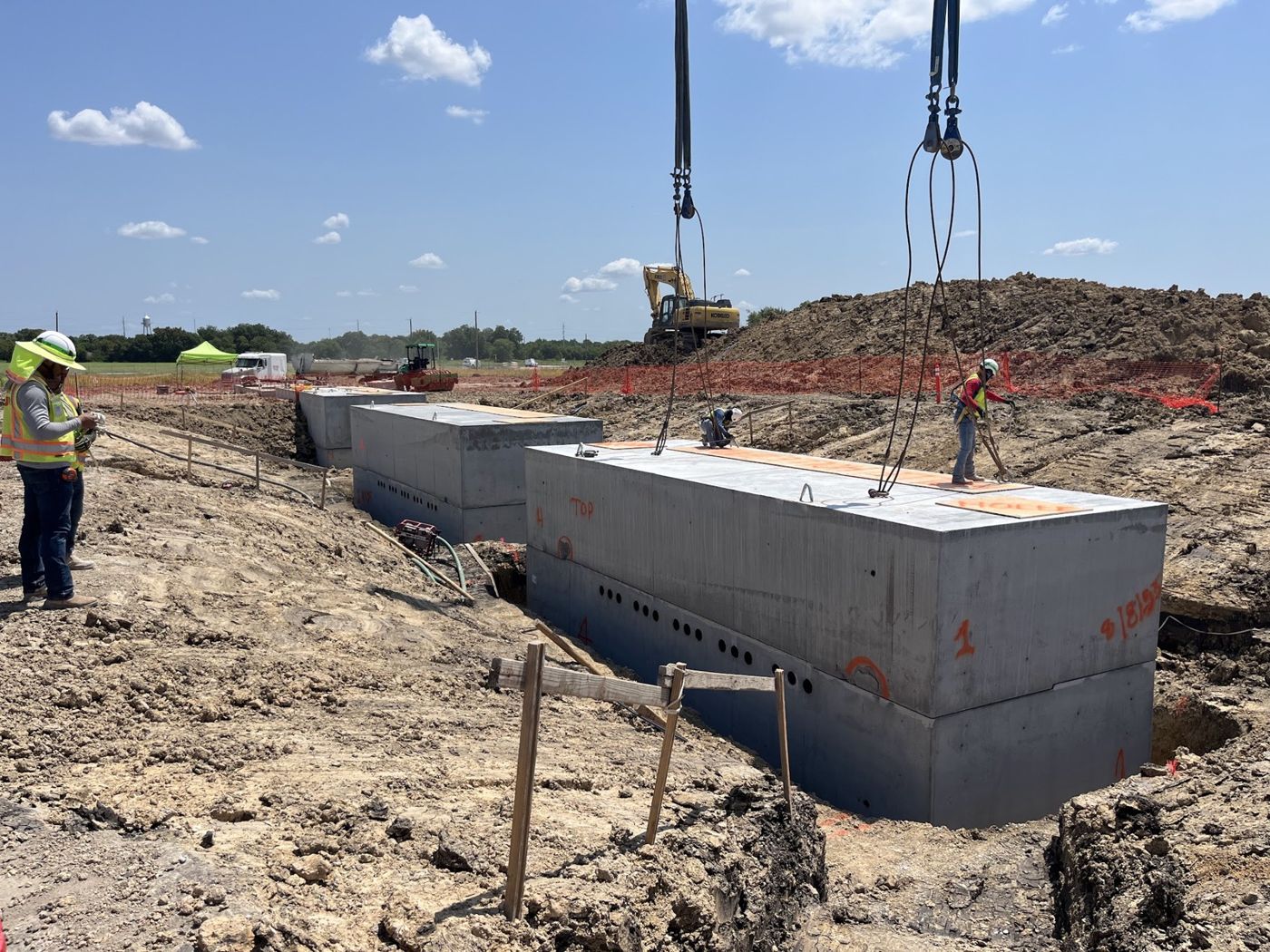 Precast vaults being set in a trench