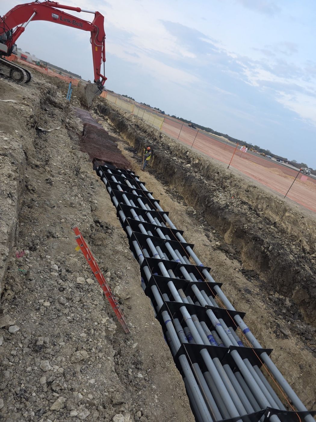 Multi-tier duct bank with excavator and crew